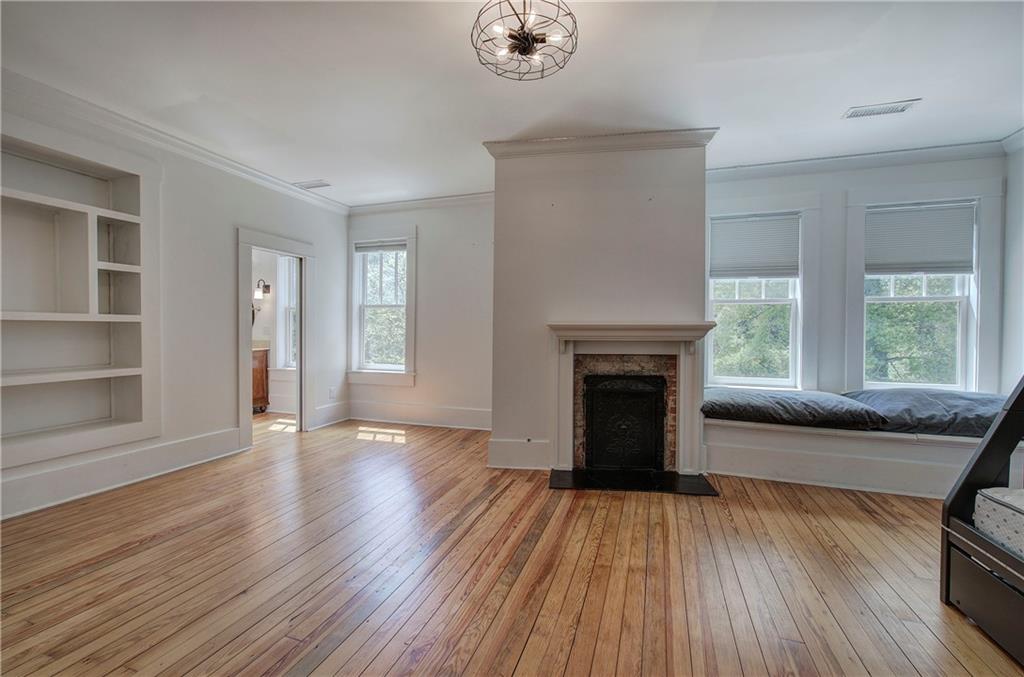 421 Boulevard Heights Calhoun, GA 30701 - Photo 54 of 96 a view of an empty room with wooden floor fireplace and a window