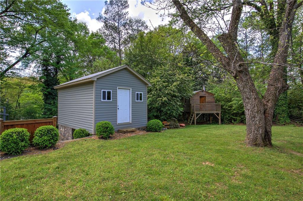 421 Boulevard Heights Calhoun, GA 30701 - Photo 86 of 96 a view of a backyard with potted plants and large trees