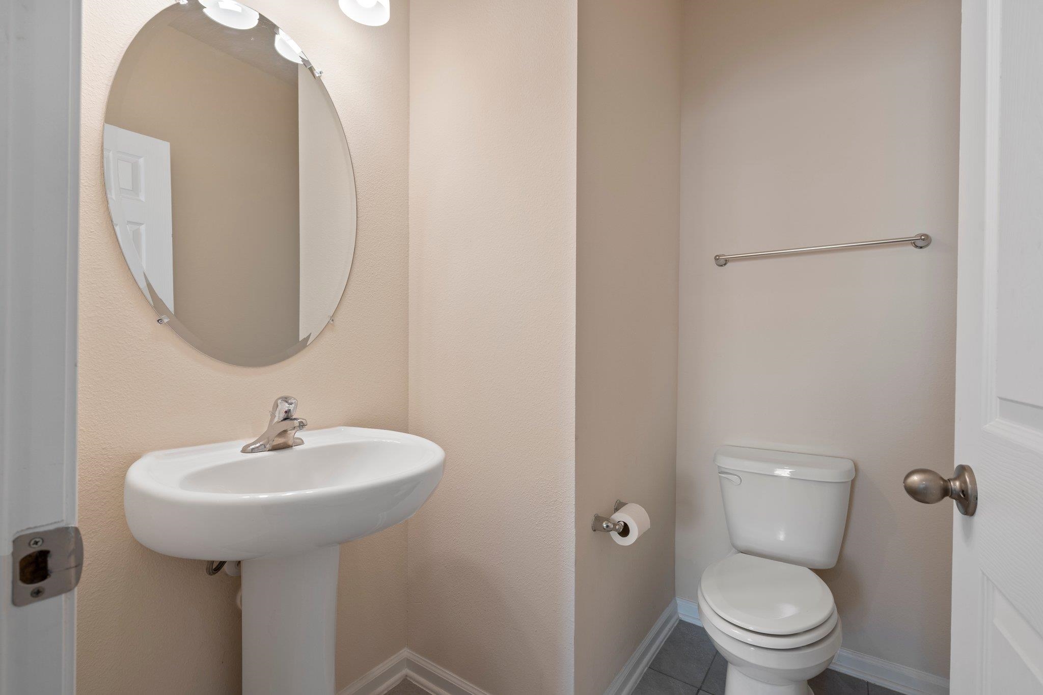553 Coastline Way Street St. Augustine, FL 32092 - Photo 11 of 35 a bathroom with a toilet sink and mirror