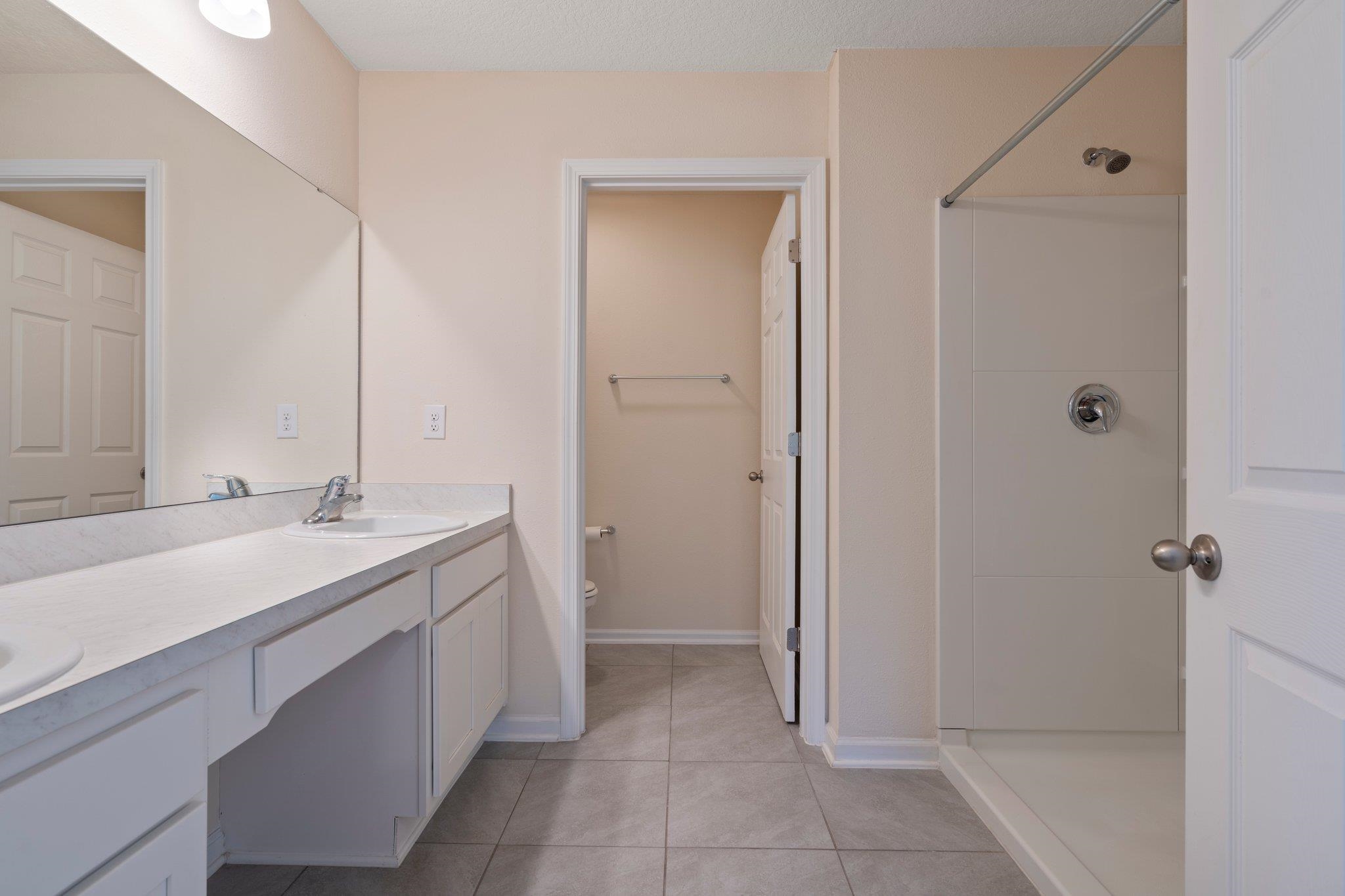 553 Coastline Way Street St. Augustine, FL 32092 - Photo 16 of 35 a bathroom with a sink and a mirror