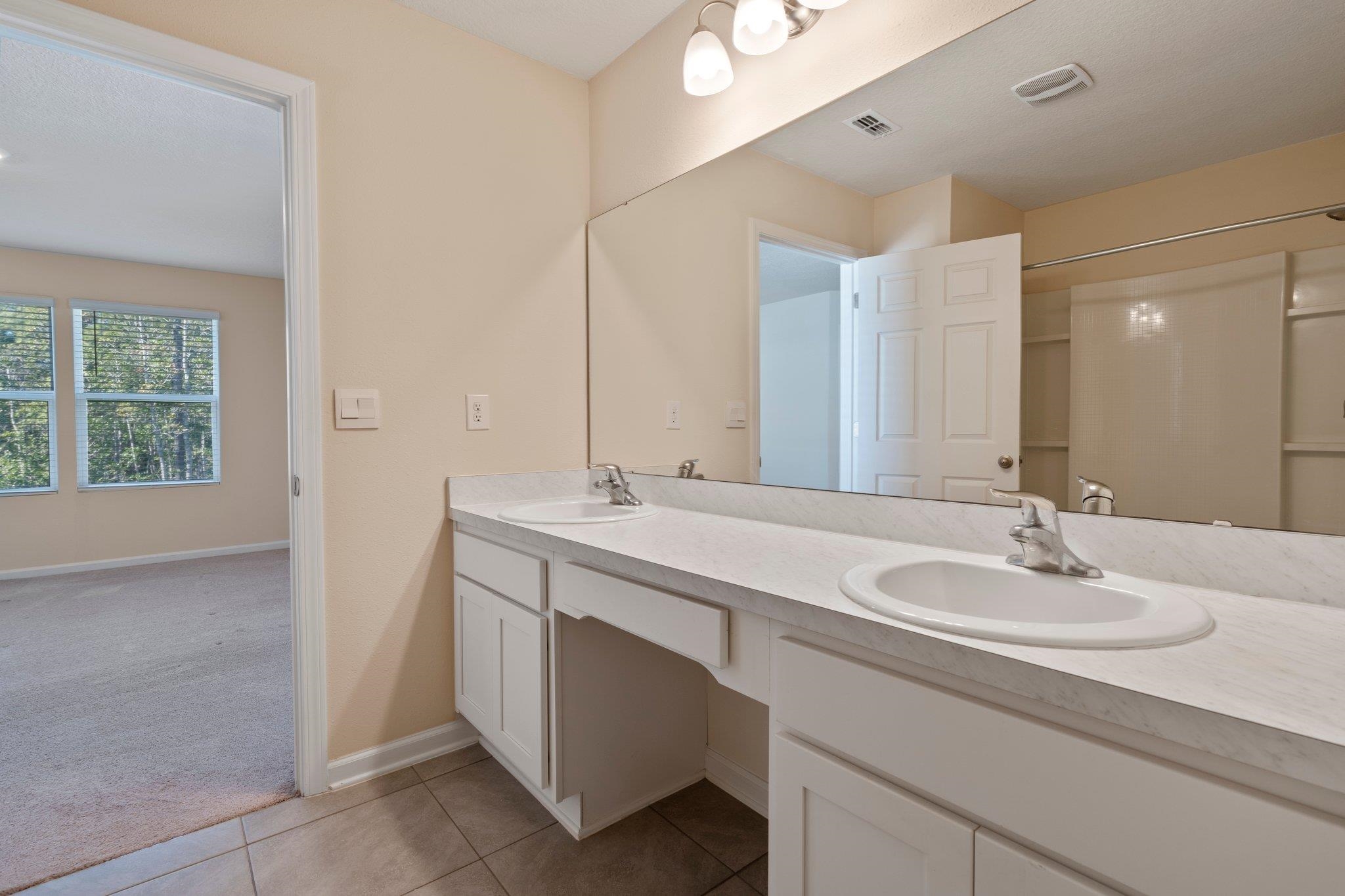 553 Coastline Way Street St. Augustine, FL 32092 - Photo 17 of 35 a bathroom with a sink and a mirror