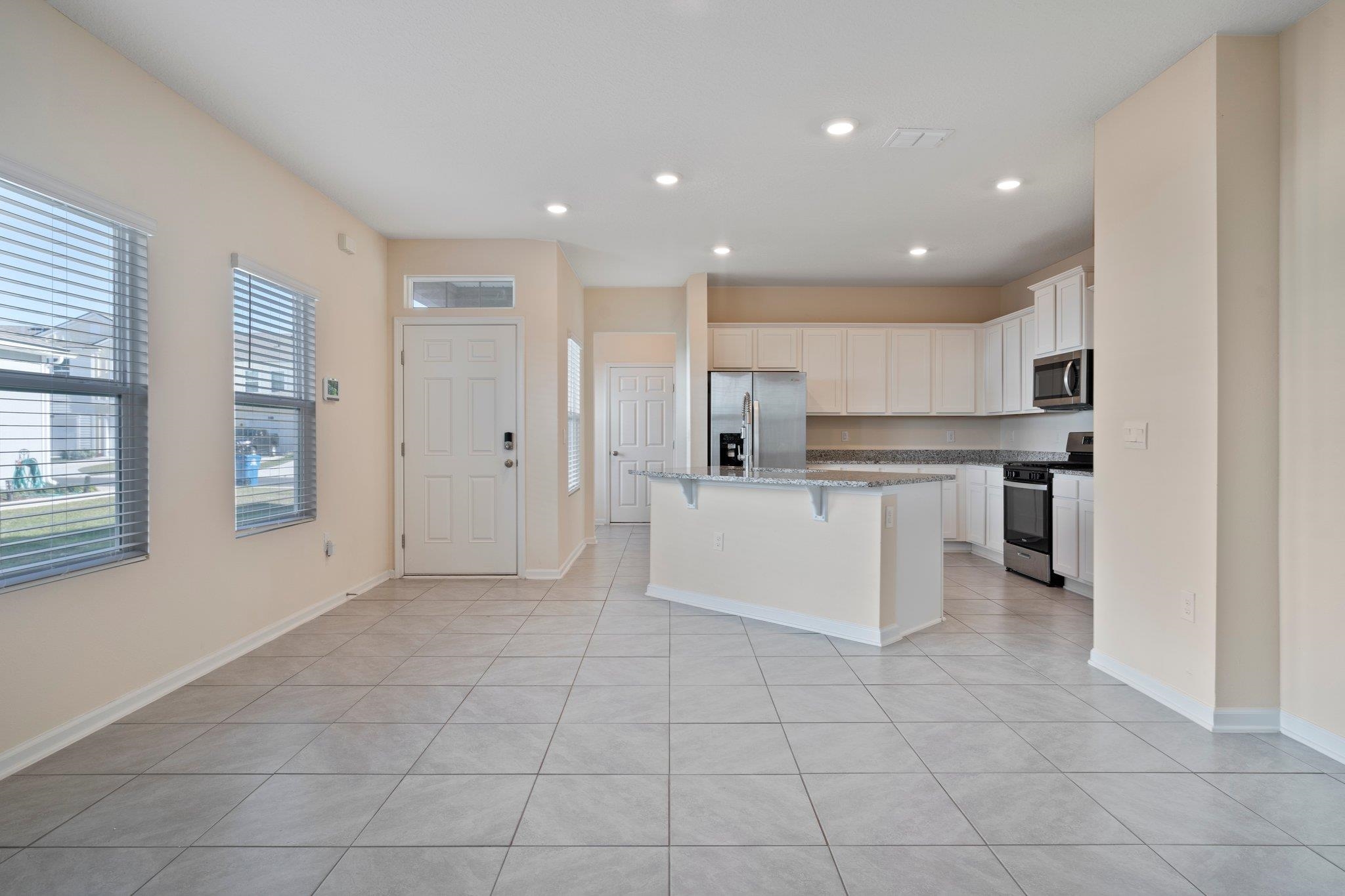 553 Coastline Way Street St. Augustine, FL 32092 - Photo 3 of 35 a kitchen with stainless steel appliances a refrigerator sink and cabinets