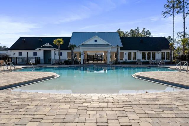 an aerial view of a house with backyard