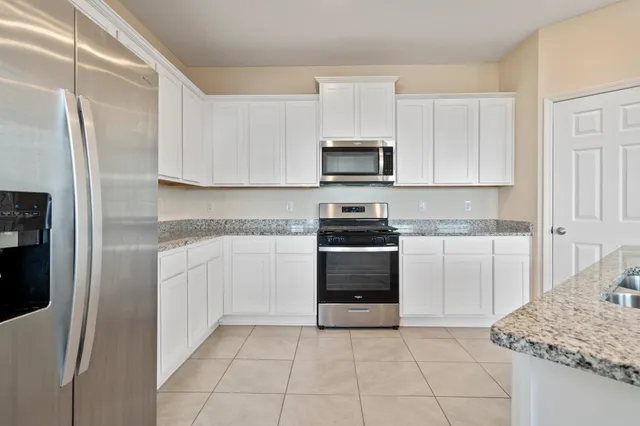 a kitchen with granite countertop a sink and a window