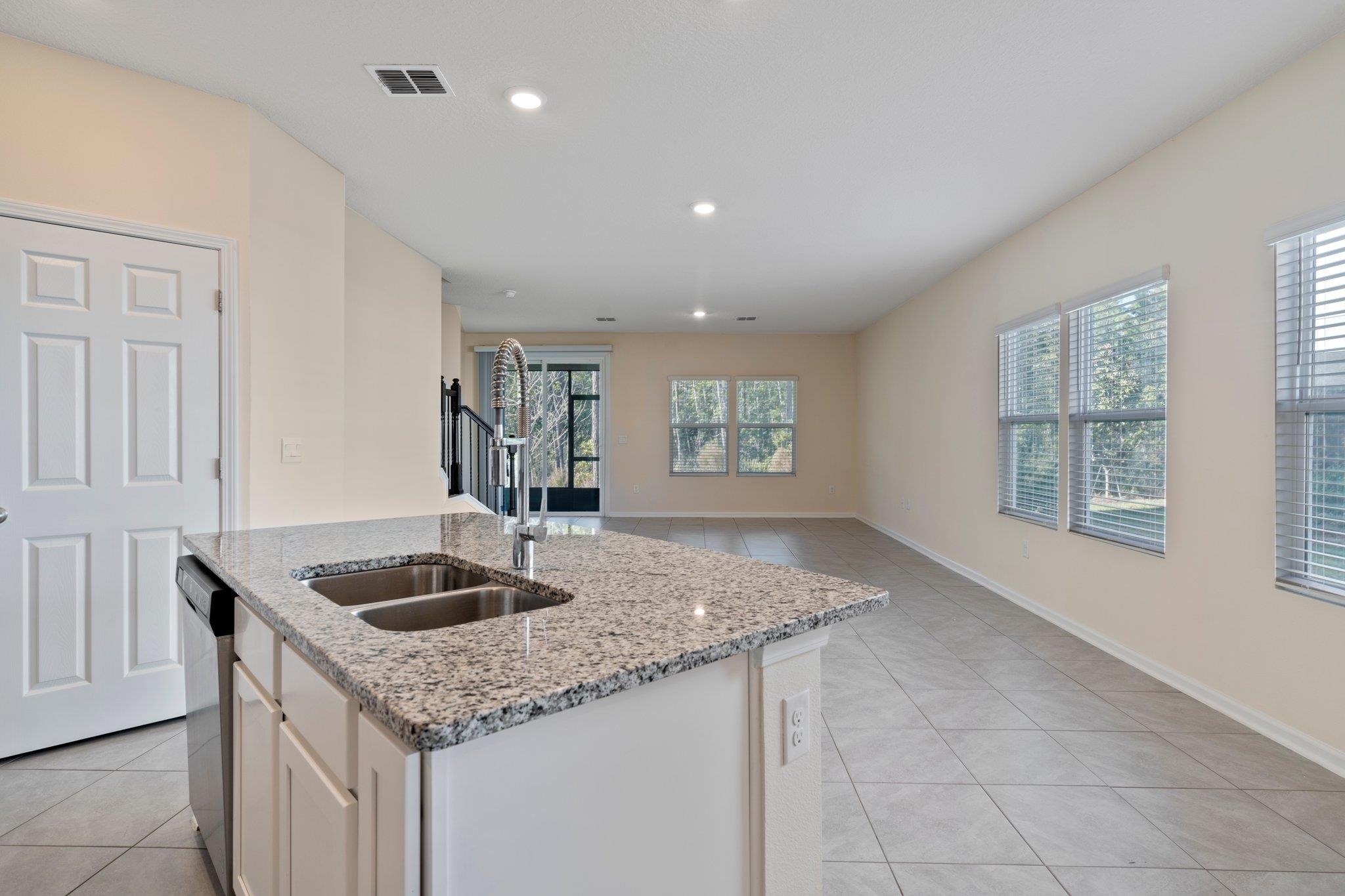 553 Coastline Way Street St. Augustine, FL 32092 - Photo 7 of 35 a kitchen with granite countertop a sink and a window