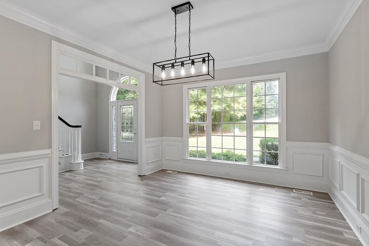 170 Fleming Forest Drive Youngsville, NC 27596 - Photo 16 of 42 a view of an empty room with wooden floor and a window