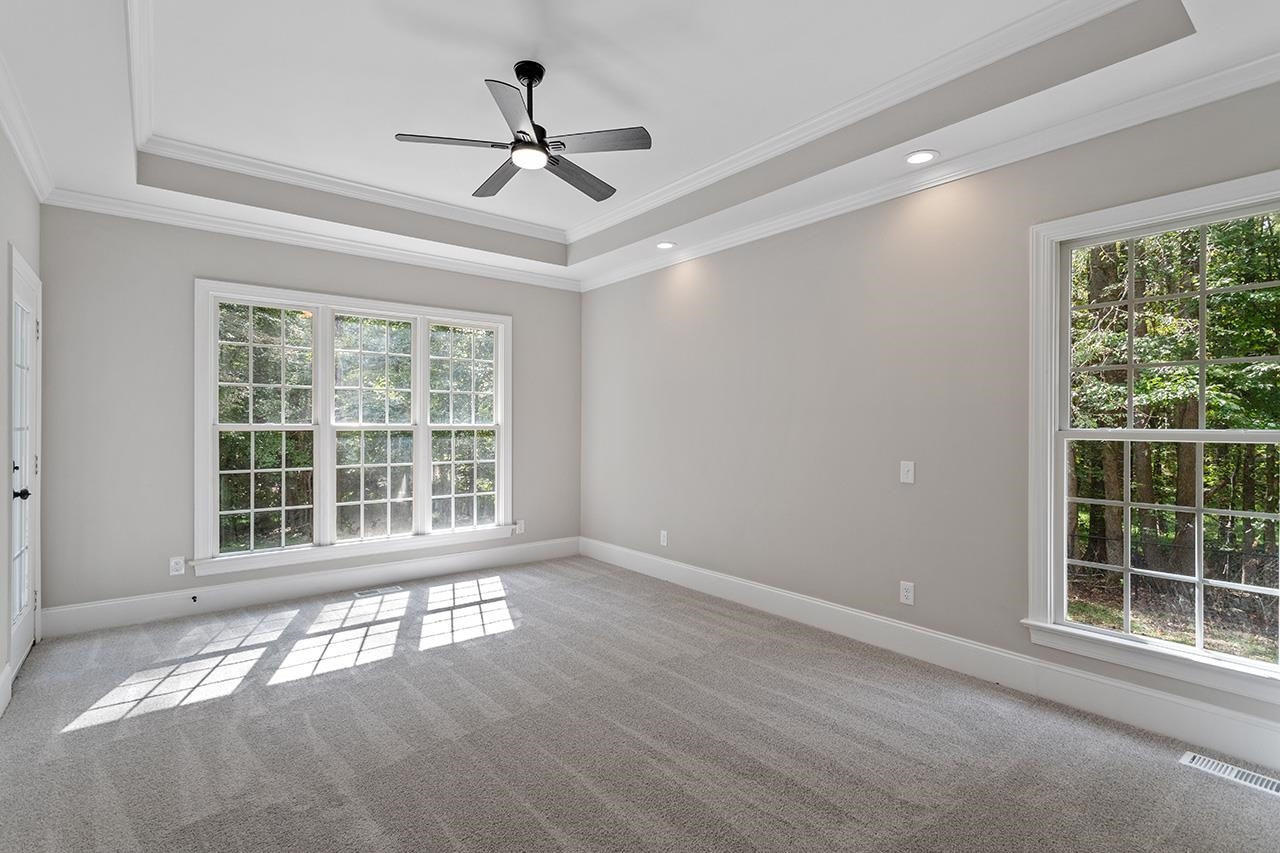 170 Fleming Forest Drive Youngsville, NC 27596 - Photo 22 of 42 a view of an empty room with a window and wooden floor