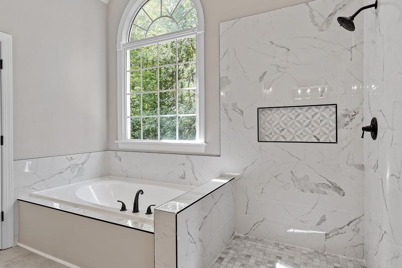 170 Fleming Forest Drive Youngsville, NC 27596 - Photo 30 of 42 a bath tub sitting next to a window