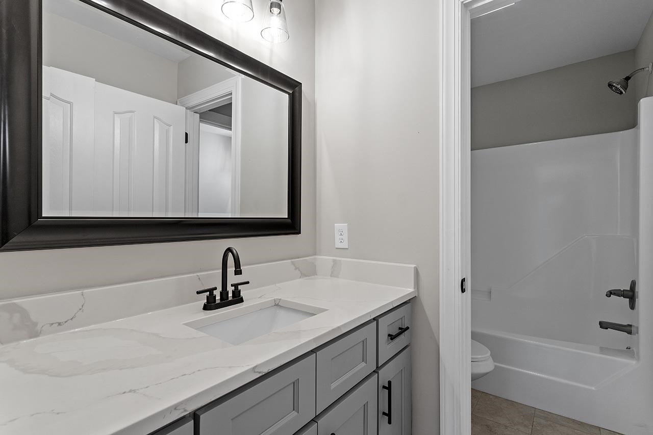170 Fleming Forest Drive Youngsville, NC 27596 - Photo 32 of 42 a bathroom with a sink and a bathtub
