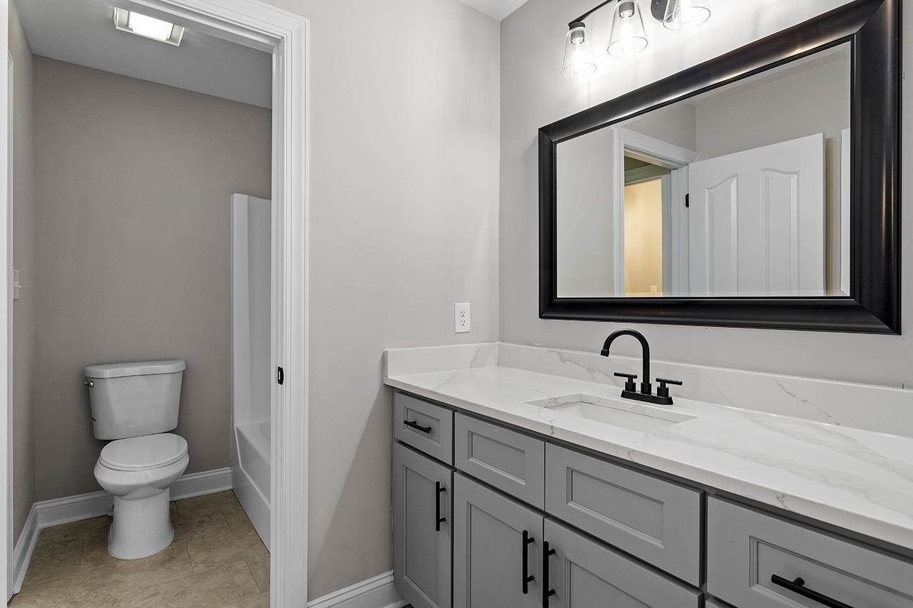 170 Fleming Forest Drive Youngsville, NC 27596 - Photo 33 of 42 a bathroom with a toilet sink and mirror