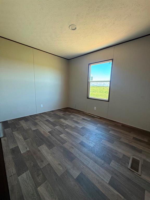 0 Southeast 4060 Road, Unit 25 Kerens, TX 75144 - Photo 15 of 18 Room featuring wood-finish flooring, neutral wall paneling, and a recessed ceiling light