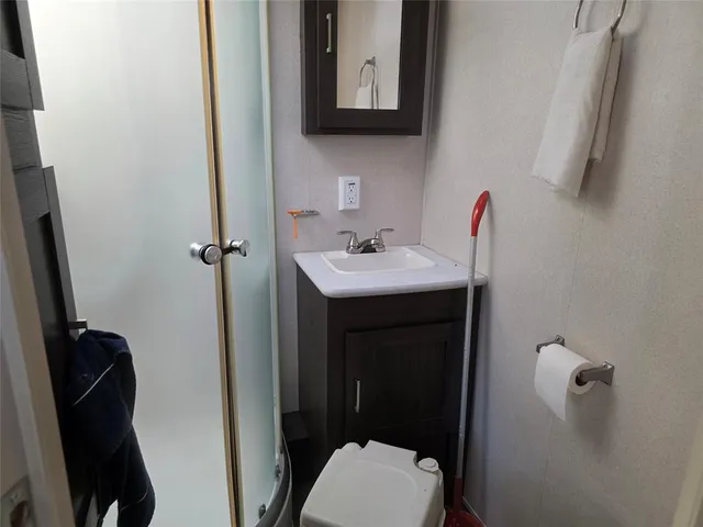 a bathroom with a sink vanity mirror and toilet