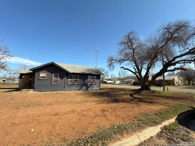 a big house with a large tree in front of it