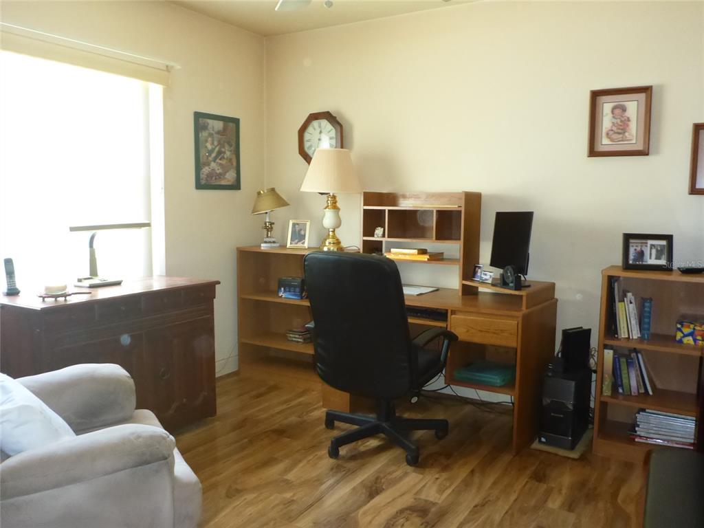 12271 Centralia Road Weeki Wachee, FL 34614 - Photo 11 of 36 a view of a workspace with furniture and a window