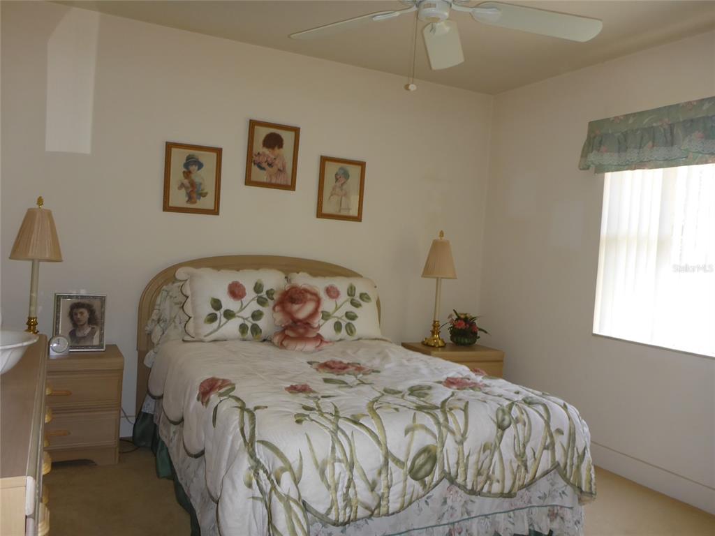 12271 Centralia Road Weeki Wachee, FL 34614 - Photo 12 of 36 a bedroom with a bed and a window