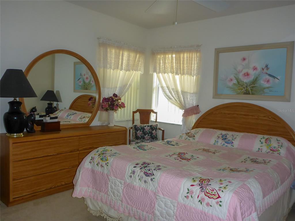 12271 Centralia Road Weeki Wachee, FL 34614 - Photo 13 of 36 a bedroom with a bed and a painting on the wall