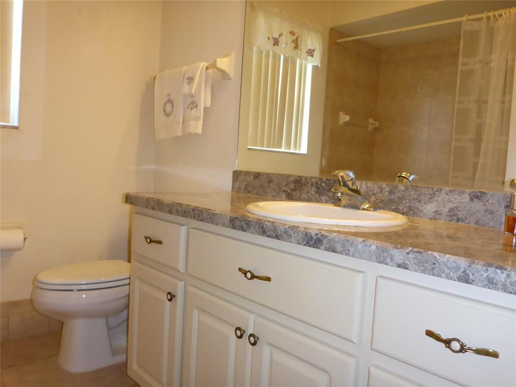 12271 Centralia Road Weeki Wachee, FL 34614 - Photo 14 of 36 a bathroom with a granite countertop sink and a mirror