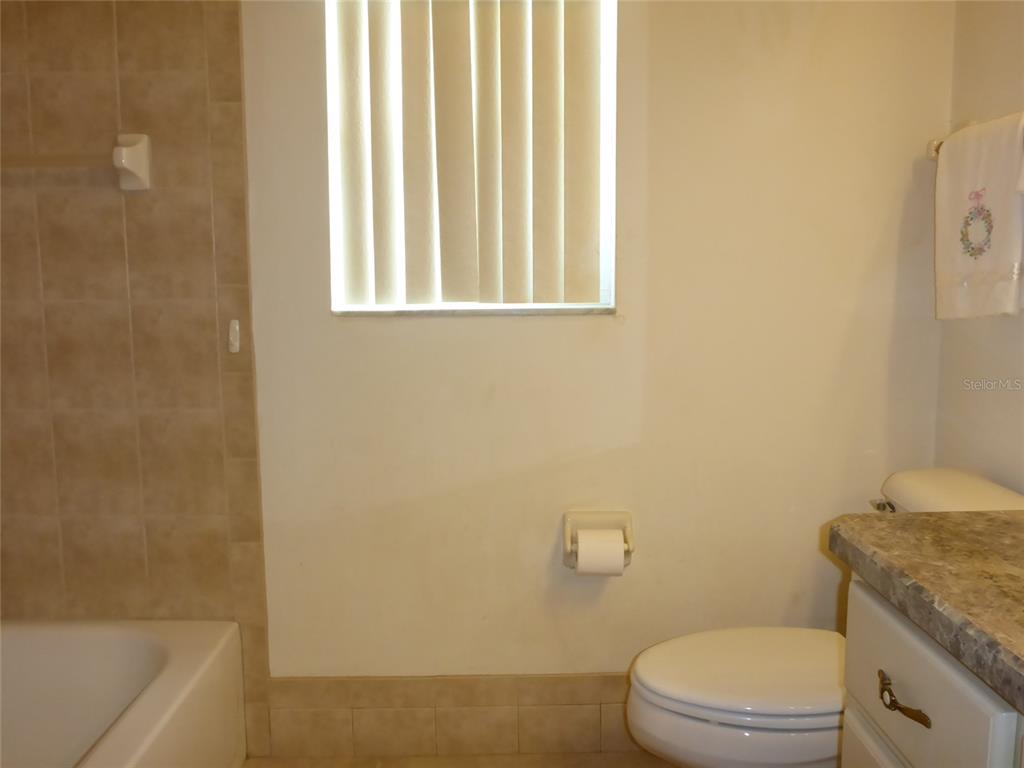 12271 Centralia Road Weeki Wachee, FL 34614 - Photo 15 of 36 a white toilet sitting next to a bath tub