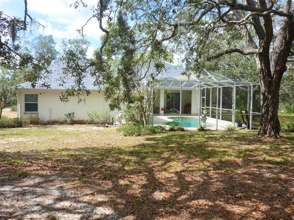 12271 Centralia Road Weeki Wachee, FL 34614 - Photo 21 of 36 a view of a house with a yard