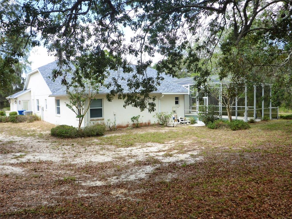 12271 Centralia Road Weeki Wachee, FL 34614 - Photo 23 of 36 a view of a house with a yard