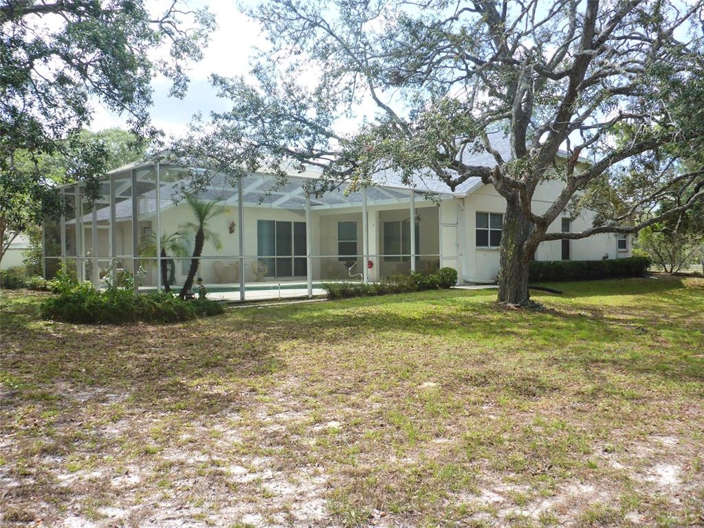 12271 Centralia Road Weeki Wachee, FL 34614 - Photo 24 of 36 a front view of a house with garden