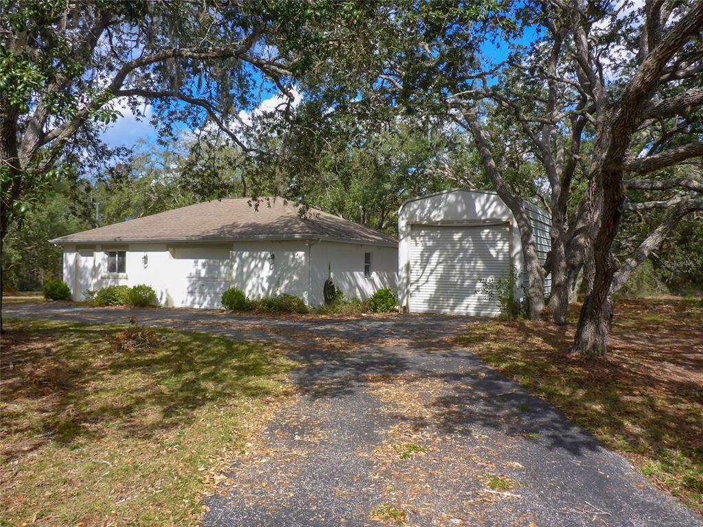 12271 Centralia Road Weeki Wachee, FL 34614 - Photo 25 of 36 a view of a house with a yard