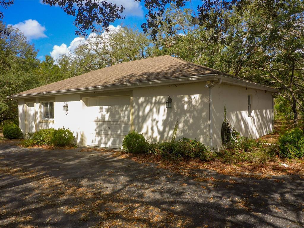 12271 Centralia Road Weeki Wachee, FL 34614 - Photo 26 of 36 a backyard of a house with large trees