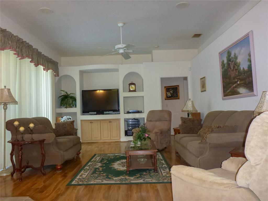12271 Centralia Road Weeki Wachee, FL 34614 - Photo 3 of 36 a living room with furniture and a flat screen tv