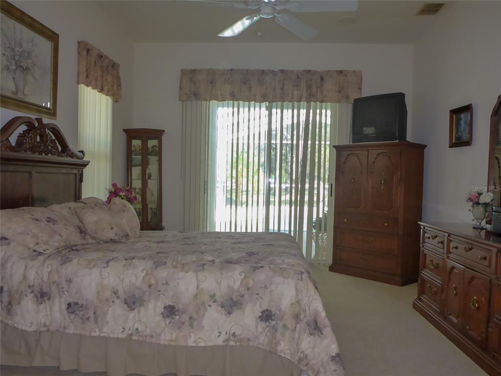 12271 Centralia Road Weeki Wachee, FL 34614 - Photo 8 of 36 a bedroom with a bed and a flat tv screen on dresser