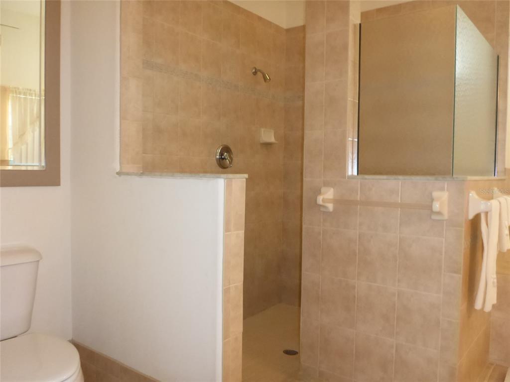 12271 Centralia Road Weeki Wachee, FL 34614 - Photo 10 of 36 a bathroom with a toilet and shower