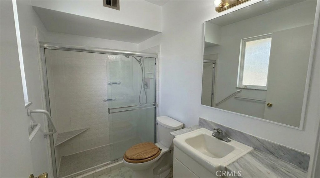27077 El Rancho Drive Menifee, CA 92586 - Photo 8 of 11 a bathroom with a sink toilet and shower