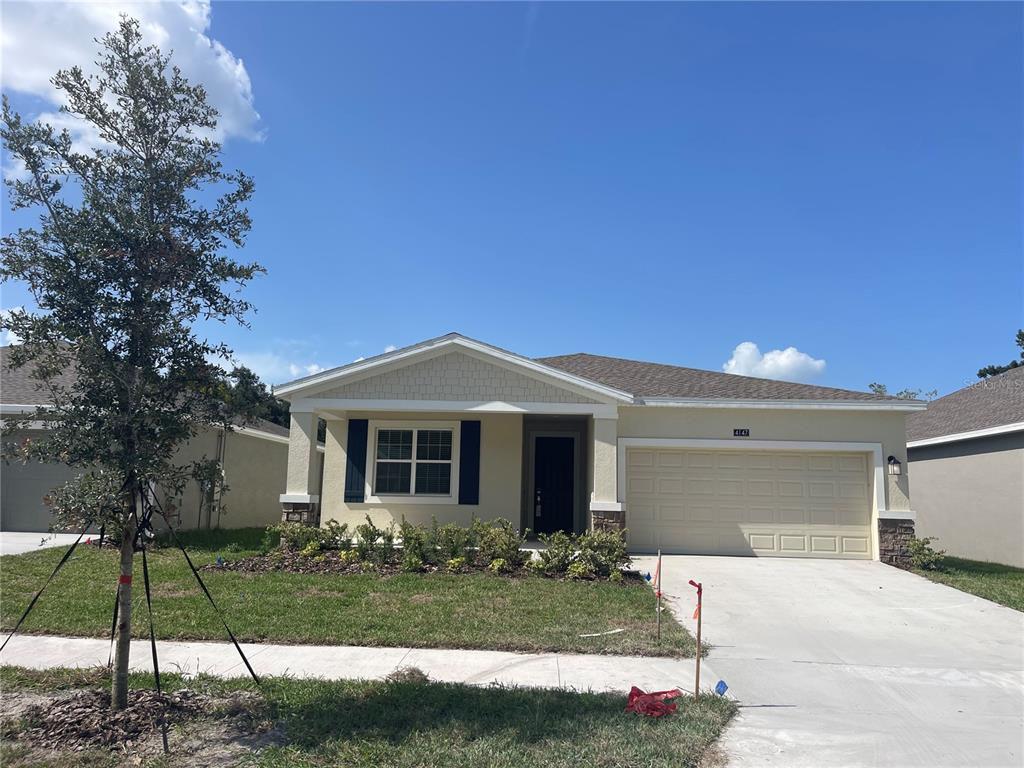 4147 Babbling Brook Way Kissimmee, FL 34746 - Photo 1 of 19 a front view of a house with garden