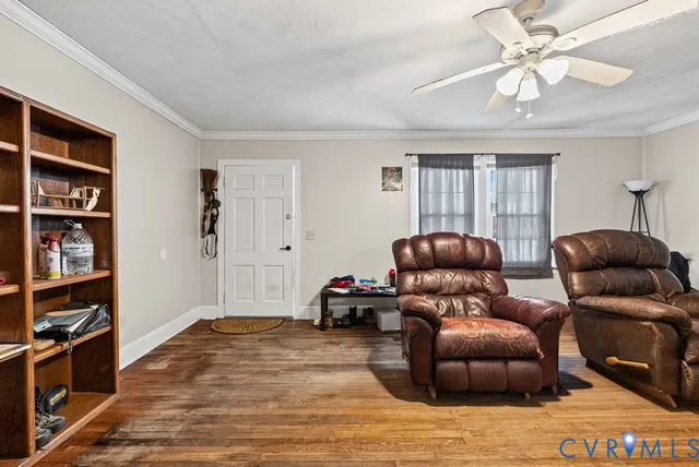 a living room with furniture and a book shelf