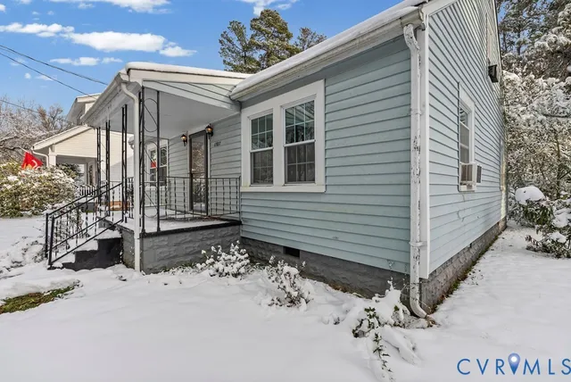 a view of a house with a snow in the yard