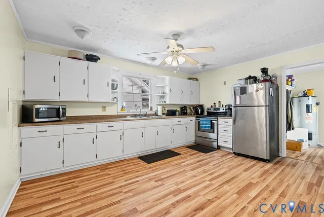 a kitchen with stainless steel appliances a refrigerator sink and cabinets