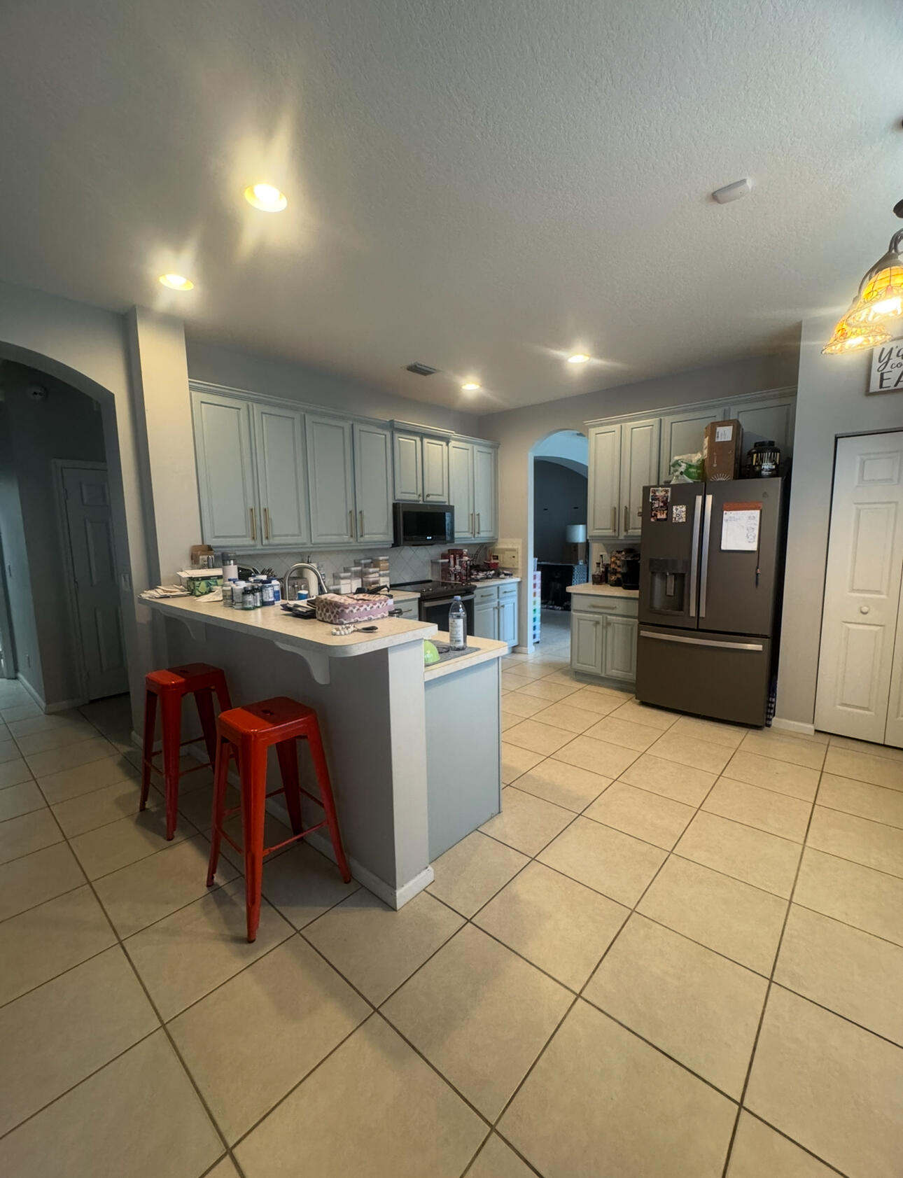 6090 46th Lane Vero Beach, FL 32967 - Photo 23 of 34 a kitchen with stainless steel appliances a refrigerator sink and cabinets