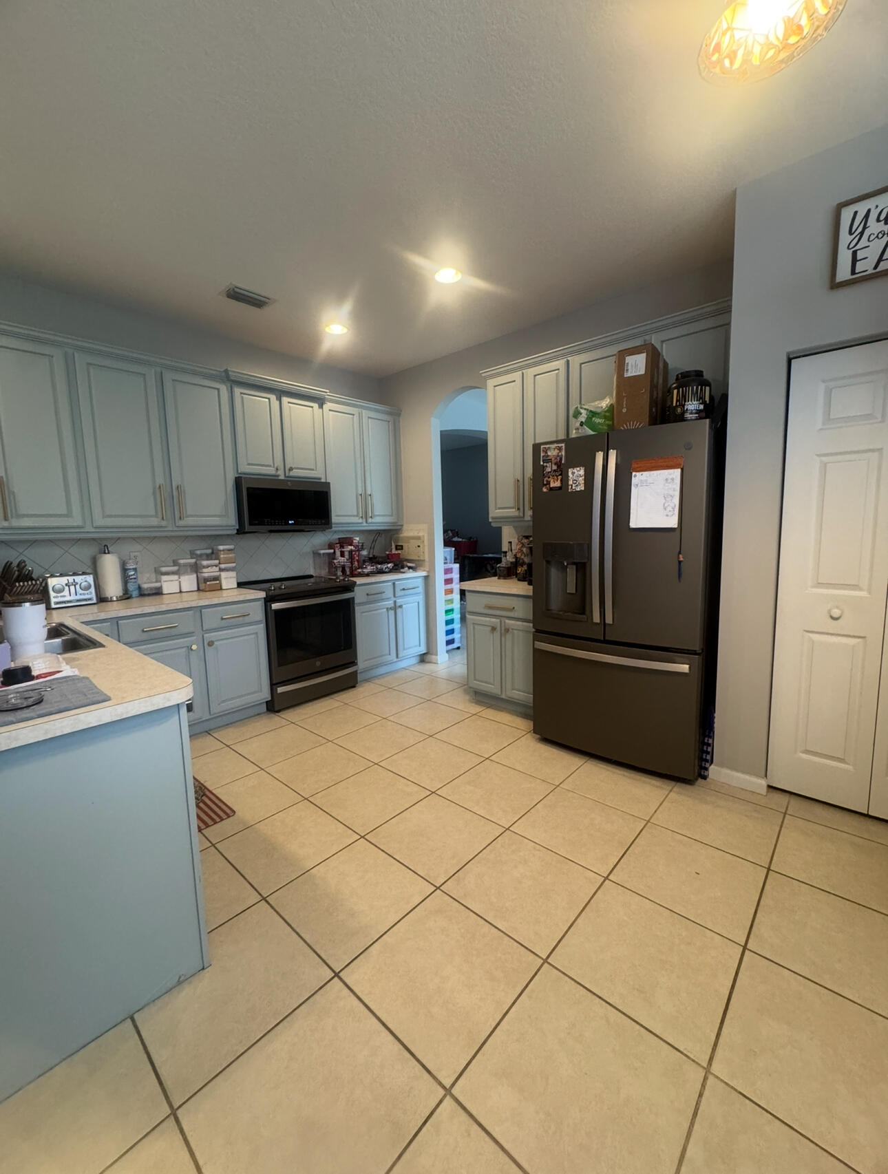 6090 46th Lane Vero Beach, FL 32967 - Photo 24 of 34 a kitchen with stainless steel appliances a refrigerator sink and microwave