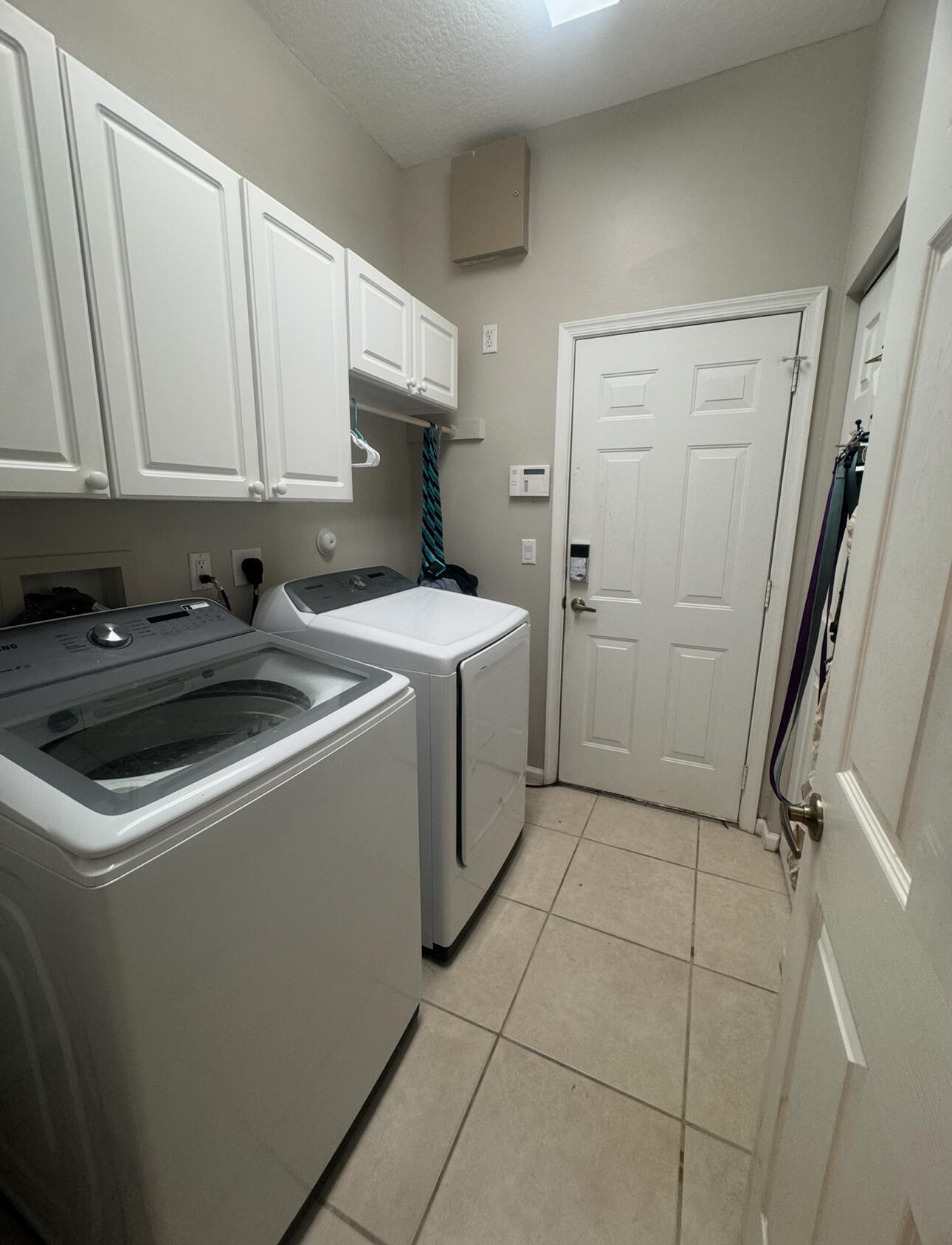 6090 46th Lane Vero Beach, FL 32967 - Photo 29 of 34 a utility room with cabinets washer and dryer