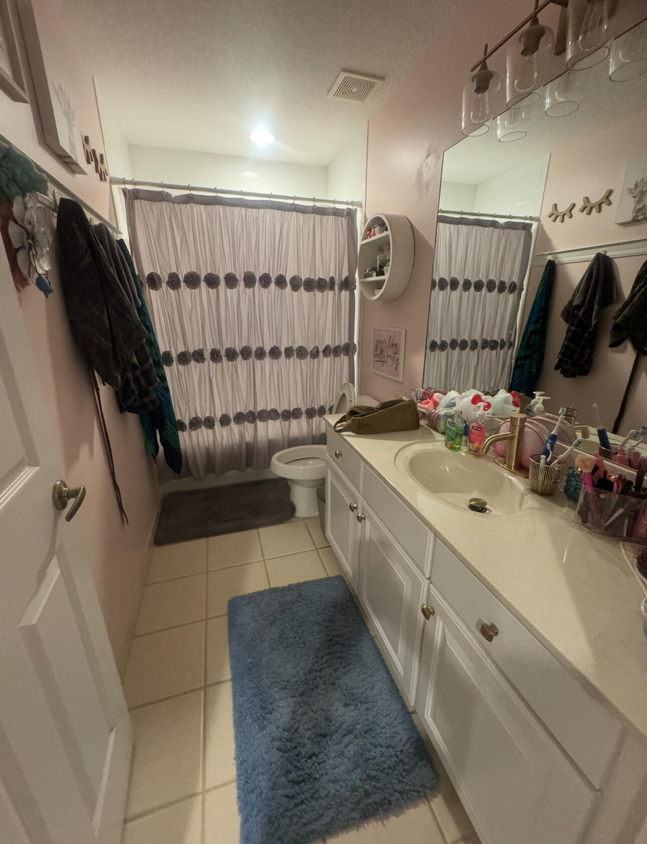 6090 46th Lane Vero Beach, FL 32967 - Photo 30 of 34 a bathroom with a sink a mirror and shower