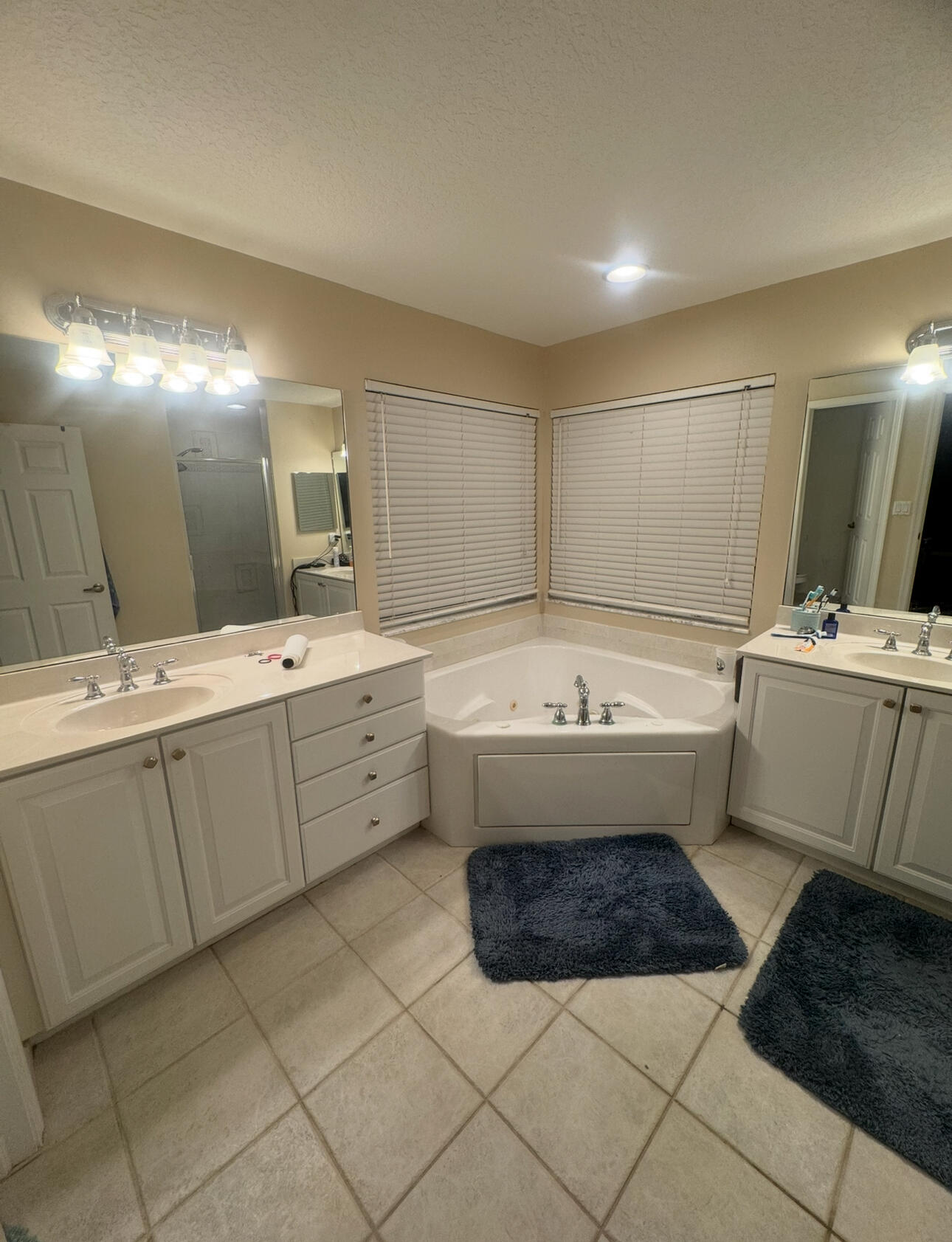 6090 46th Lane Vero Beach, FL 32967 - Photo 32 of 34 a bathroom with a sink a toilet and mirror