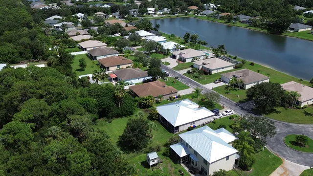an aerial view of a house with a yard