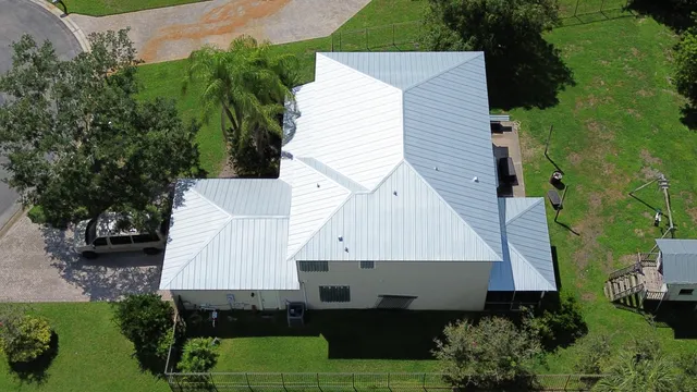 an aerial view of a house with a lake view