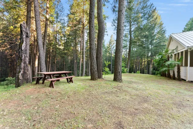 a kitchen with granite countertop a sink and white cabinets