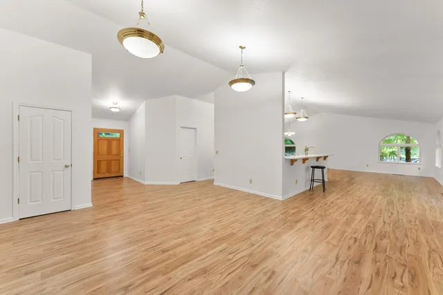 an empty room with windows and entrance