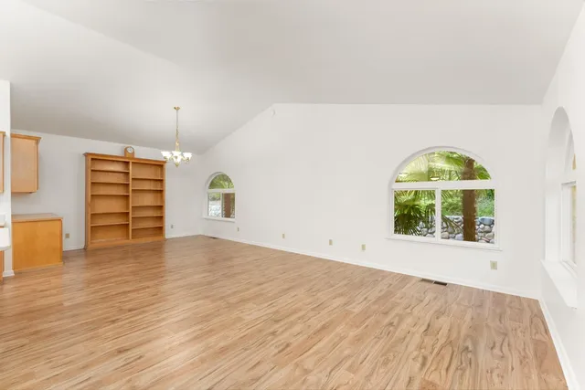 a view of room with wooden floor and outdoor space
