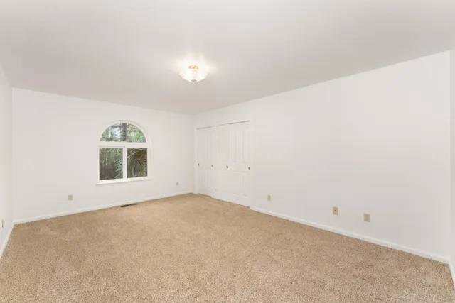 a living room with furniture and a book shelf
