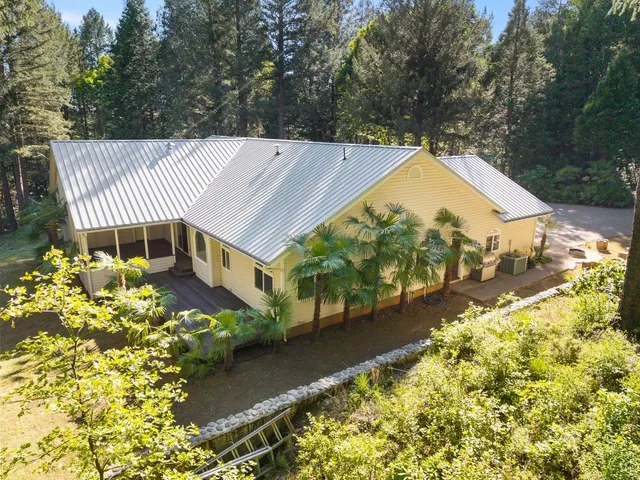a large kitchen with stainless steel appliances granite countertop a stove and a wooden floors