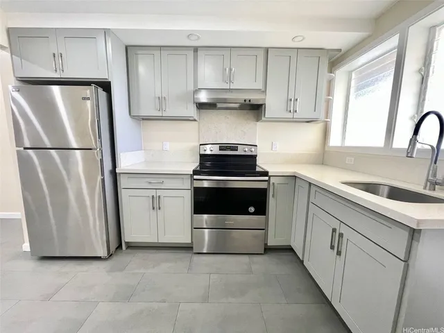 a kitchen with white cabinets and white stainless steel appliances