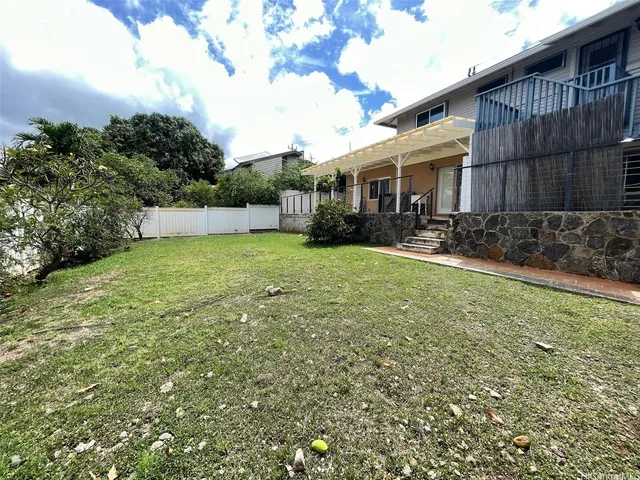 a view of a house with a yard and sitting area