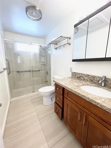 a spacious bathroom with a granite countertop sink a toilet and shower